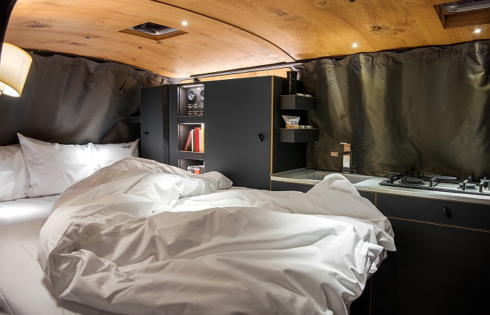 The bedroom of the Holzklasse by Nils Holger Moormann & CustomBus (bed linen included)